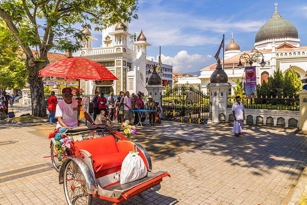 A local rickshaw (tuk tuk) outside Kapitan Keling Mosque, in George Town, Penang Island, Malaysia, Southeast Asia, Asia