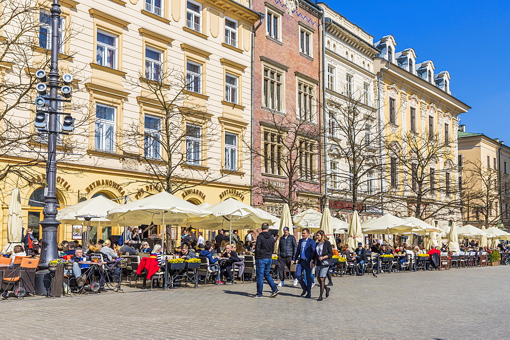 A cafe scene in the main square, Rynek Glowny, in the medieval old town, UNESCO World Heritage Site, Krakow, Poland, Europe