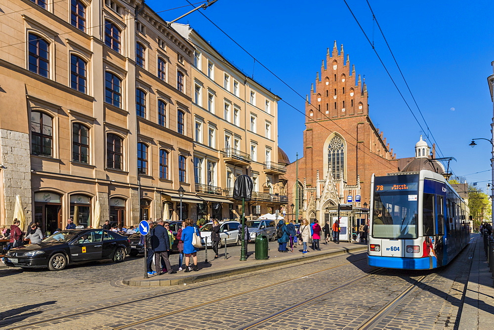 A tram outside the Dominican church in the medieval old town, UNESCO World Heritage Site, in Krakow, Poland, Europe