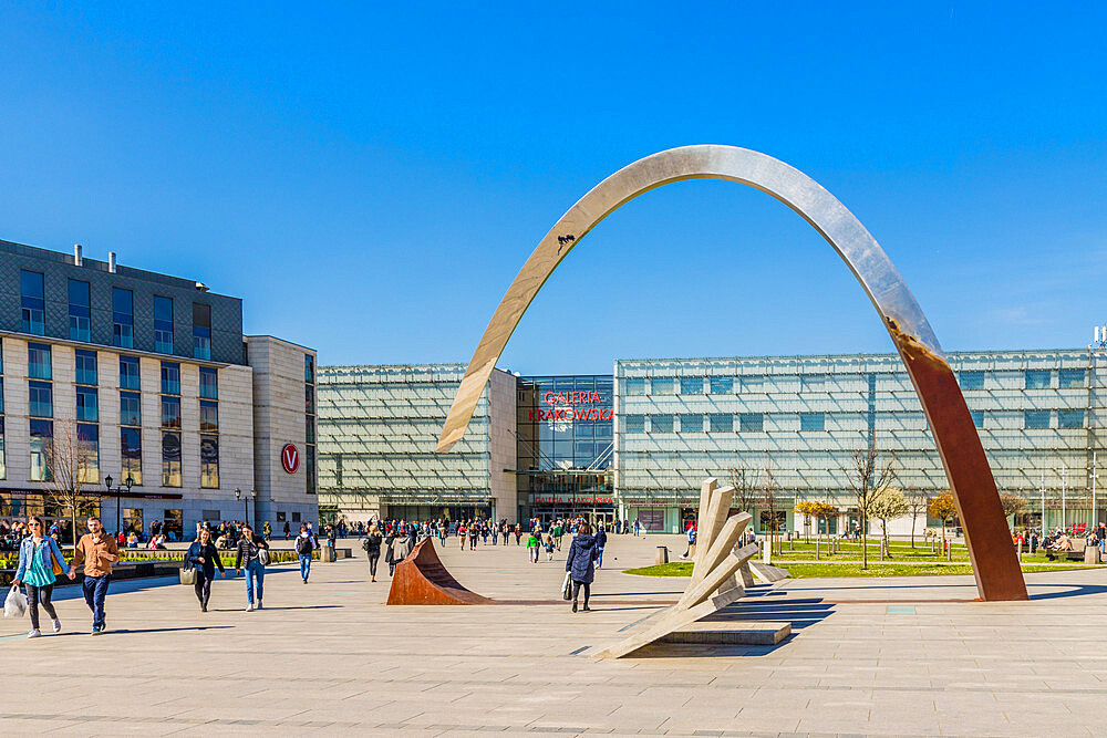 The Pomnik Ryszarda Kuklinskiego w Krakowie sculpture and the Galeria Krakowska Shopping centre mall in Krakow, Poland, Europe