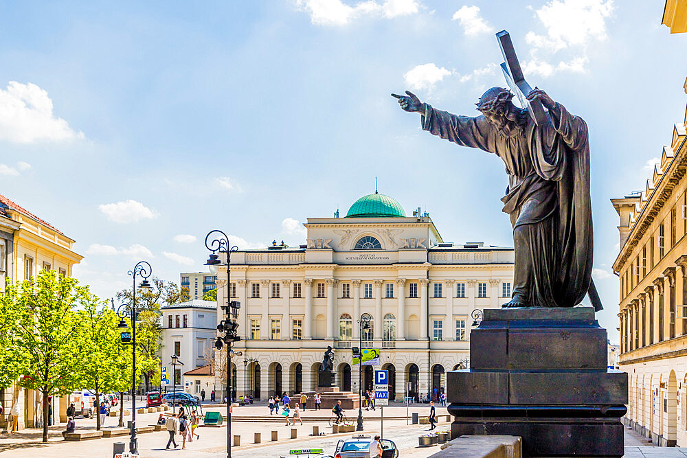 A statue and the Polish Academy of Sciences in the background, Old Town, UNESCO World Heritage Site, Warsaw, Poland, Europe