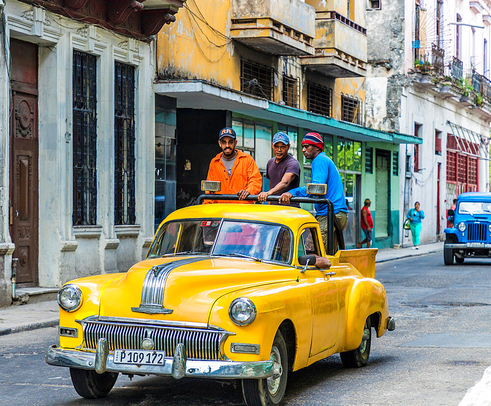 Local men riding in a vintage car, Havana, Cuba, West Indies, Caribbean, Central America