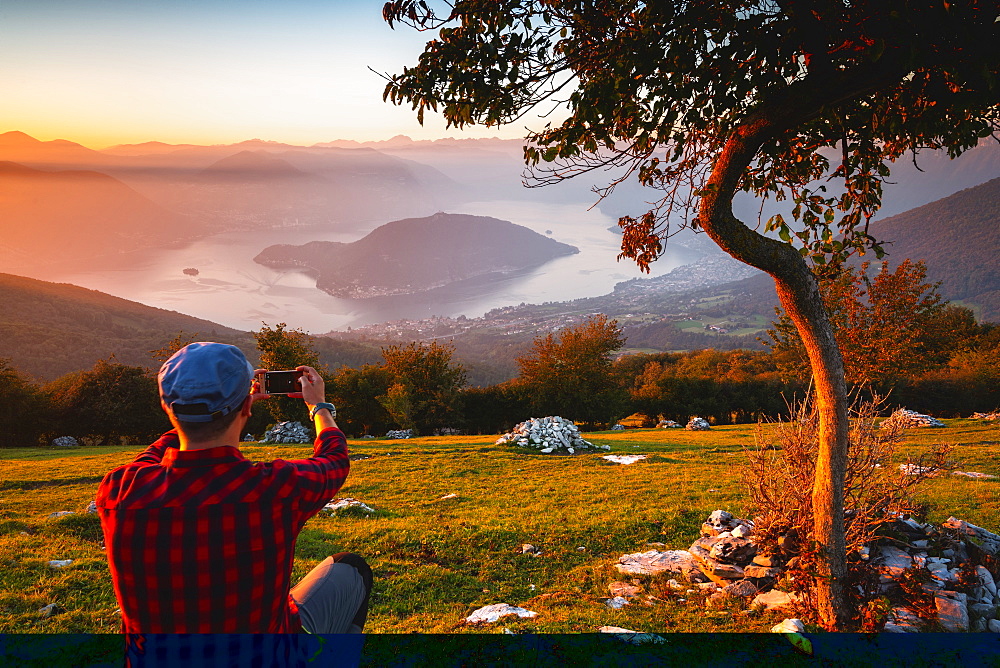 Hikers admiring the mountains in autumn season in Stelvio National Park in Brescia Province, Lombardy, Italy, Europe