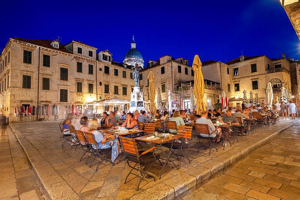 People eating at outdoor restaurant at night in the old town, Dubrovnik, Croatia, Europe