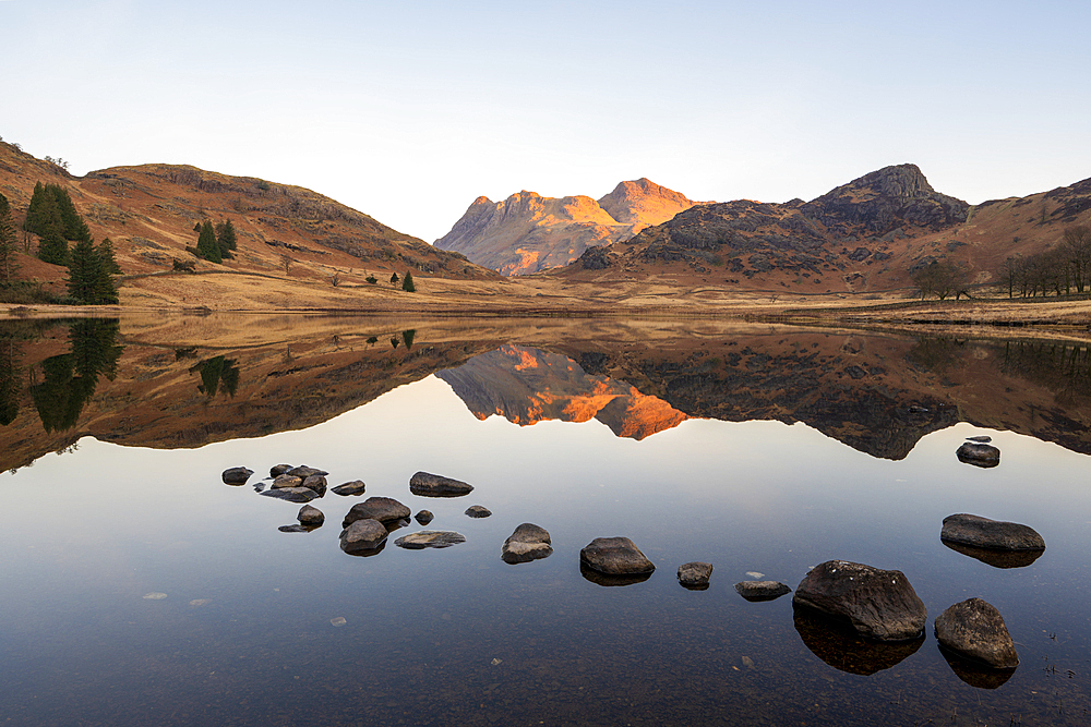 Sunrise light over Blea Tarn and the Langdale Pikes in spring, Lake District National Park Cumbria