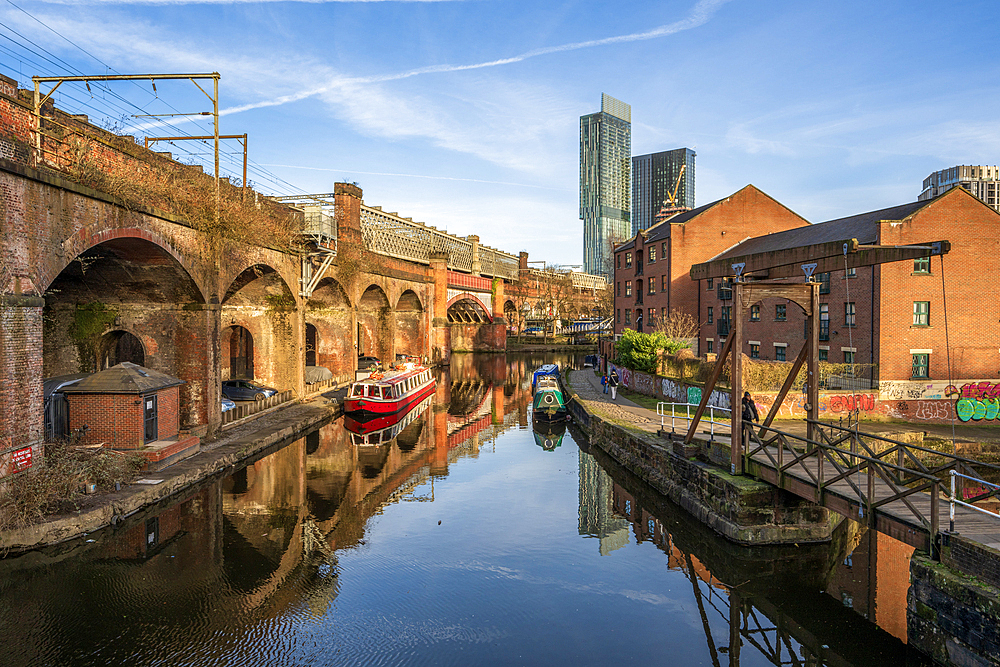 Castlefield basin with a red barge and view of Beetham Tower, Manchester