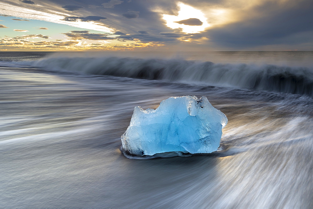 Glacier ice on Diamond Beach with crashing waves, near Jokulsarlon, South Iceland, Iceland, Polar Regions