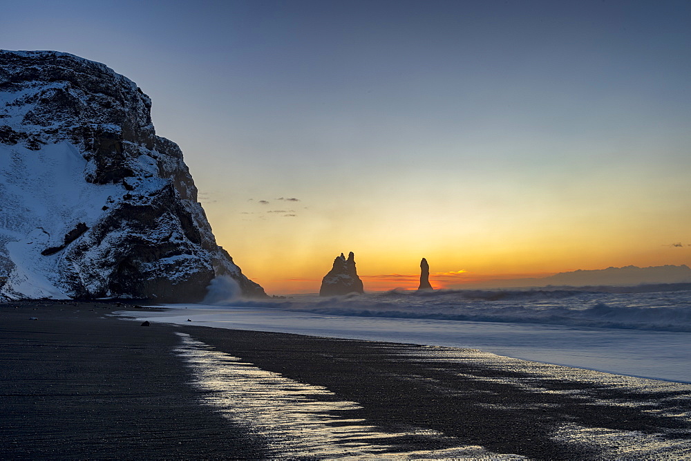 Rock stacks of Reynisdrangar at sunrise, from Halsanefs Hellir Beach near Vik, South Iceland, Iceland, Polar Regions