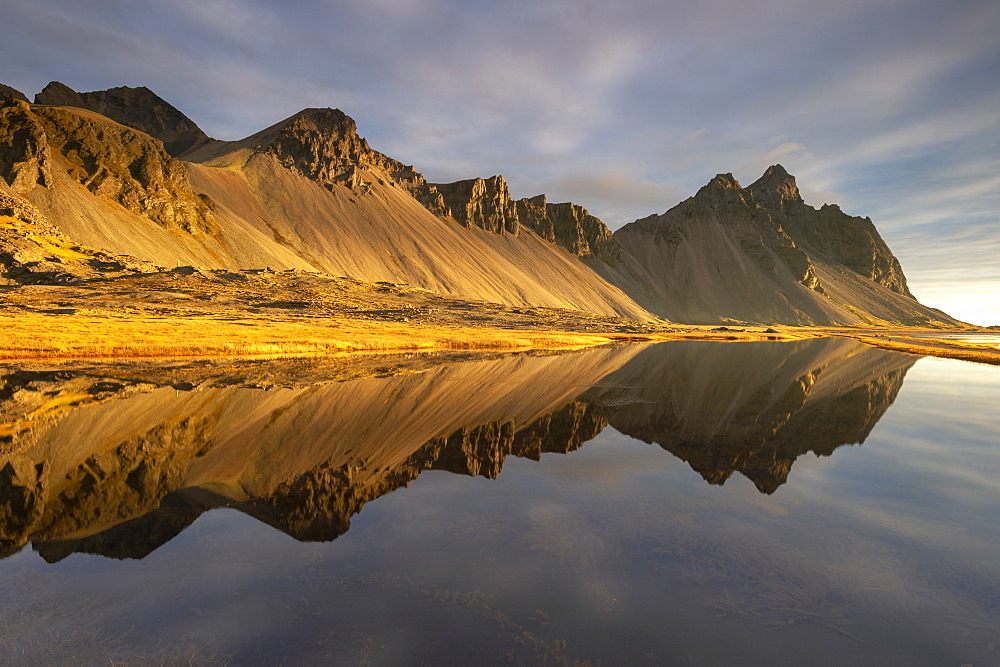 View of mountains of Vestrahorn and perfect reflection in shallow water, soon after sunrise, Stokksnes, South Iceland, Iceland, Polar Regions