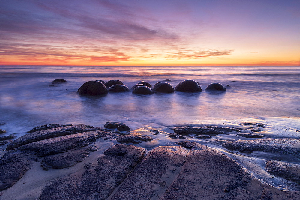 The Moeraki Boulders with incredible sunrise, Moeraki Beach, Otago, South Island, New Zealand, Pacific