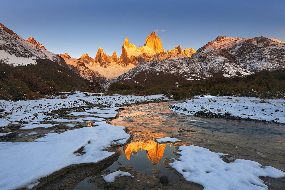 Mountain range with Cerro Fitz Roy at sunrise reflected in river, Los Glaciares National Park, UNESCO World Heritage Site, El Chalten, Patagonia, Argentina, South America