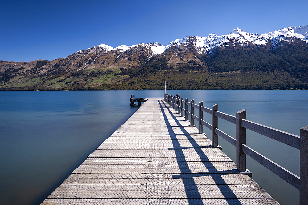 Wooden jetty leading into turquoise Lake Wakitipu, Queenstown, Otago, South Island, New Zealand, Pacific