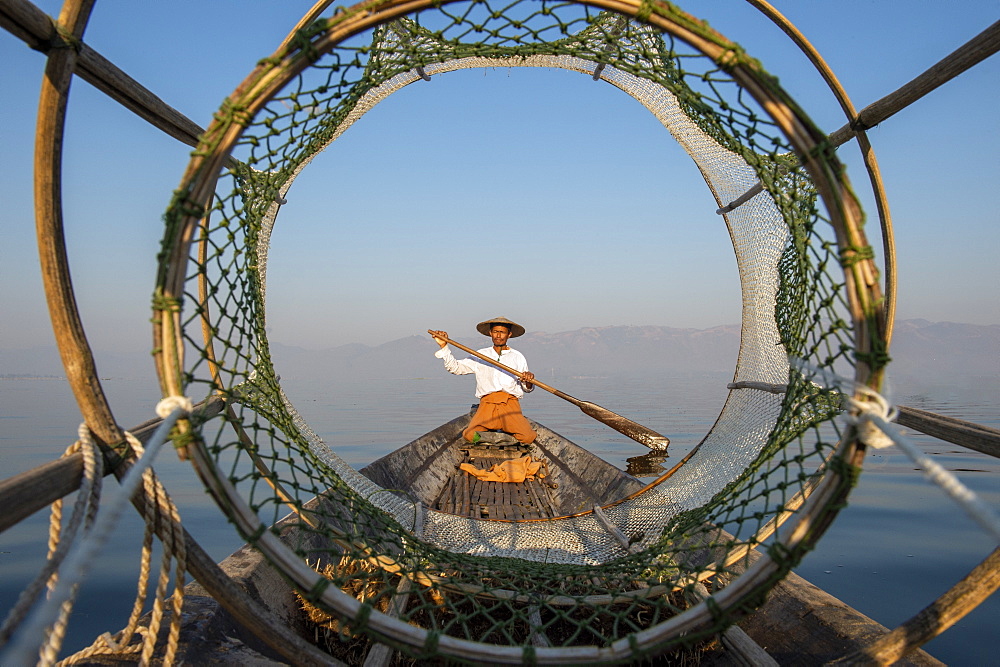 Intha leg rowing fisherman looking through fishing net, Inle Lake, Shan State, Myanmar (Burma), Asia