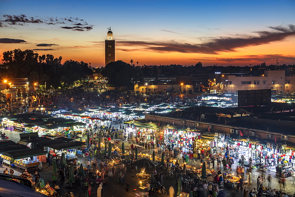 View over the Djemaa el Fna at dusk showing food stalls and crowds of people, Marrakech, Morocco, North Africa, Africa