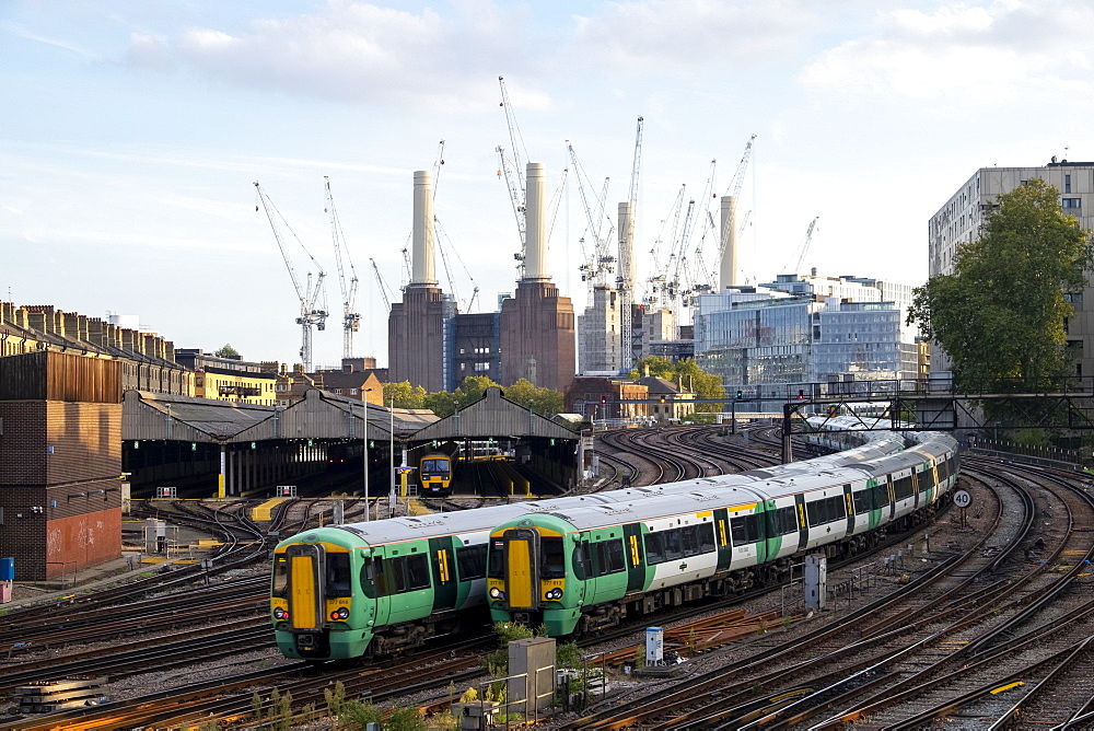 Passenger trains travelling towards London Victoria station with Battersea Power Station under construction, London, England, United Kingdom, Europe