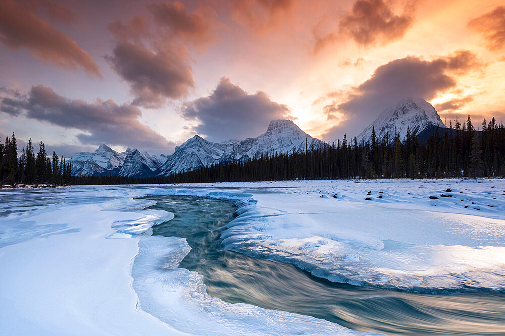 Athabasca River in winter with mountain backdrop, Alberta, Canada, North America