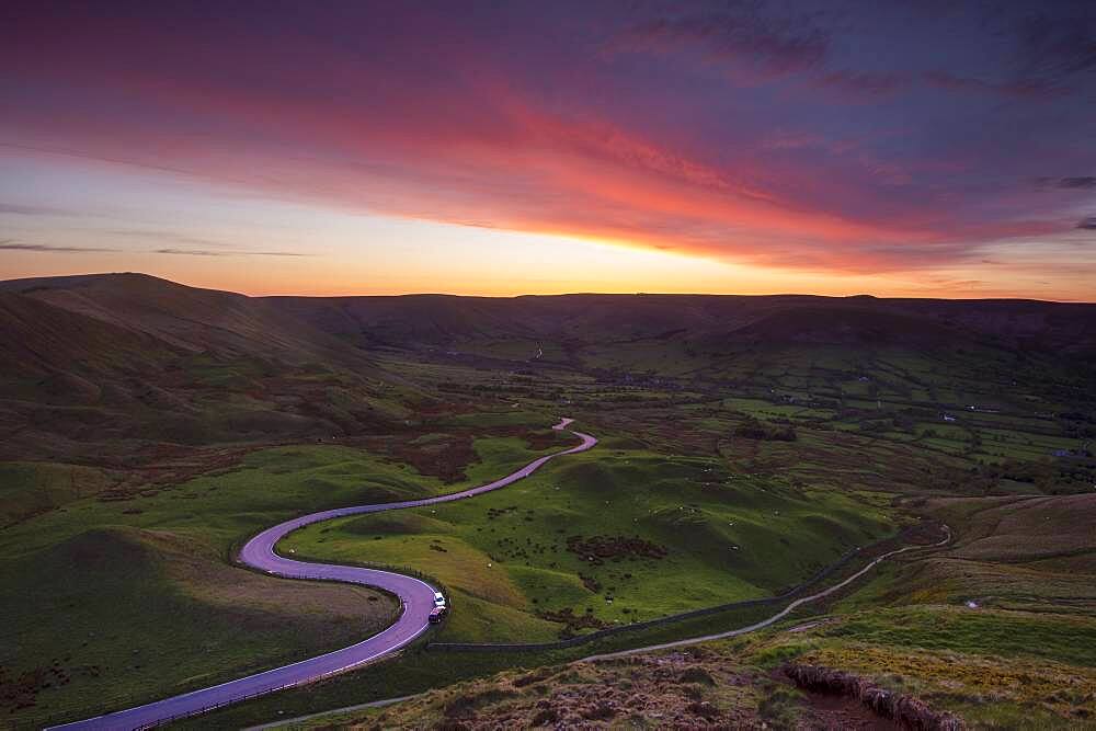 Spectacular sunset at Rushup Edge with winding road leading to Edale, Peak District, Derbyshire, England, United Kingdom, Europe