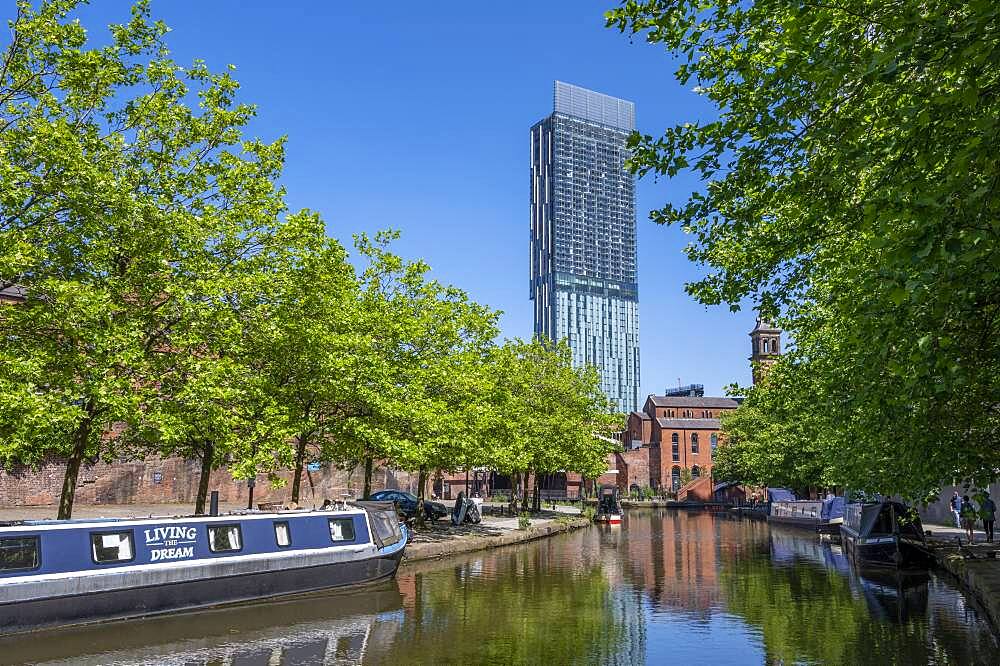 Moored canal boats at Castlefield Canal Basin with the Beetham Tower, Manchester, England, United Kingdom, Europe