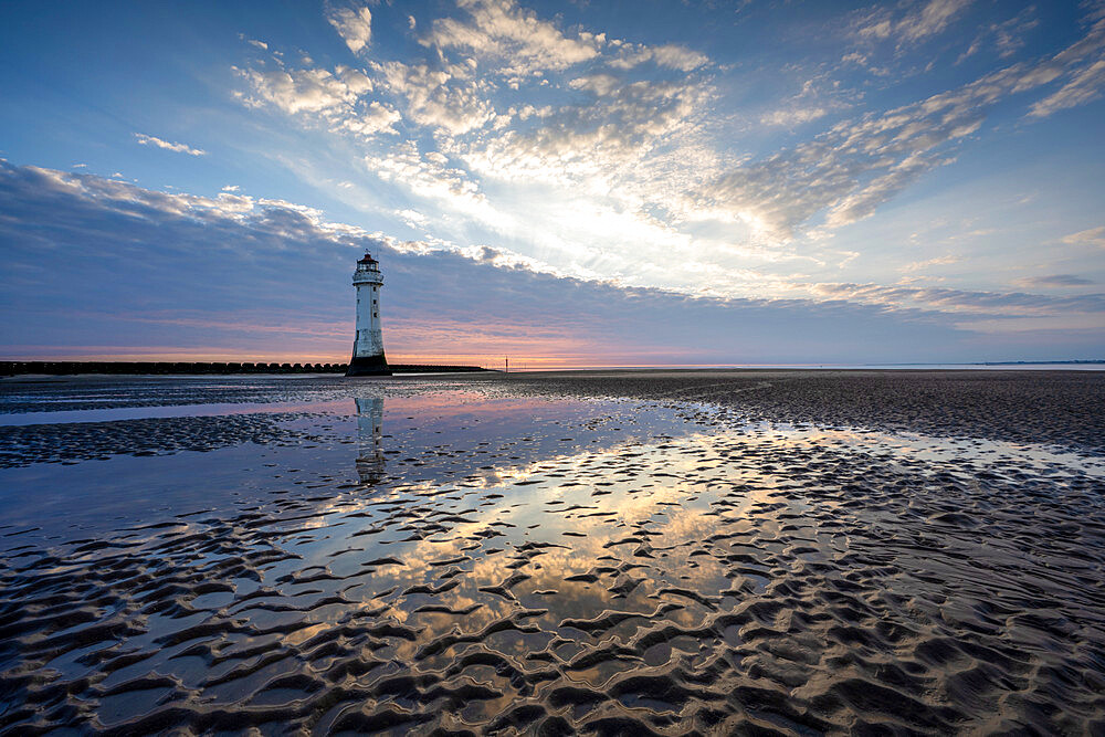 New Brighton Lighthouse reflected in sand at sunset, New Brighton, Cheshire, England, United Kingdom, Europe