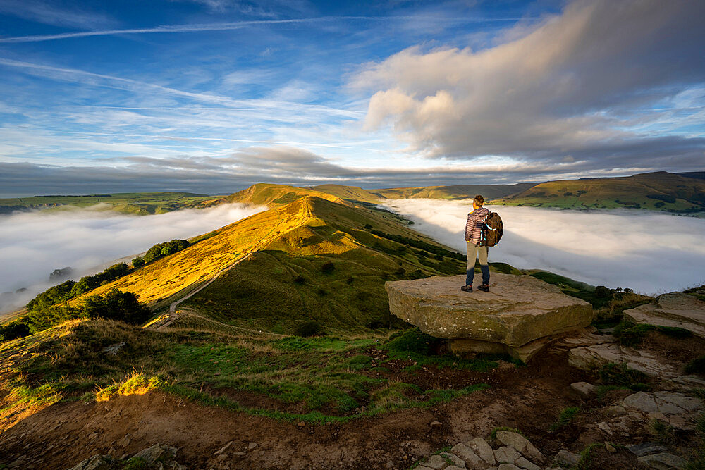 A man looking across The Great Ridge during a cloud inversion with view of Mam Tor, Hope Valley, Peak District, Derbyshire, England, United Kingdom, Europe