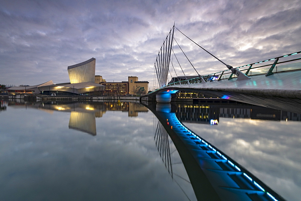 Pedestrian bridge over canal and Imperial War Museum North in Salford Quays, Manchester, England, United Kingdom, Europe