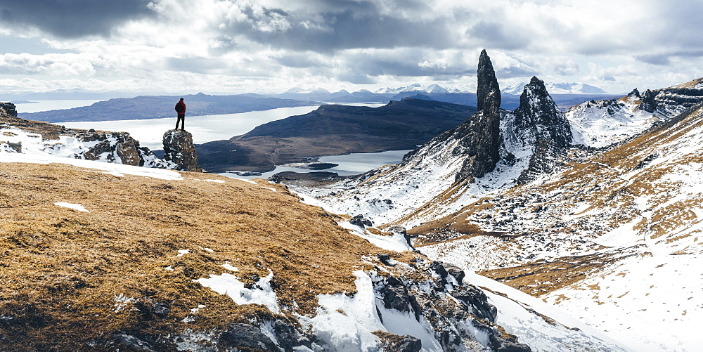 Hiker admiring view towards the Old Man of Storr, near Portree, Isle of Skye, Inner Hebrides, Highland, Scotland, United Kingdom, Europe