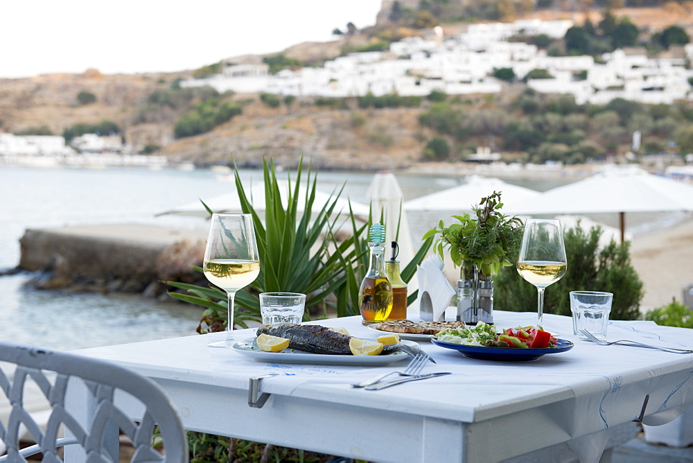 Fish and salad served at a Greek restaurant by the sea, Lindos, Rhodes, Dodecanese, Greek Islands, Greece, Europe