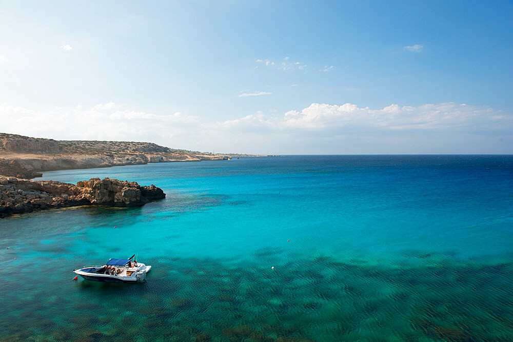 Boat in the water overlooking Cape Greco, Protaras, Cyprus, Mediterranean, Europe