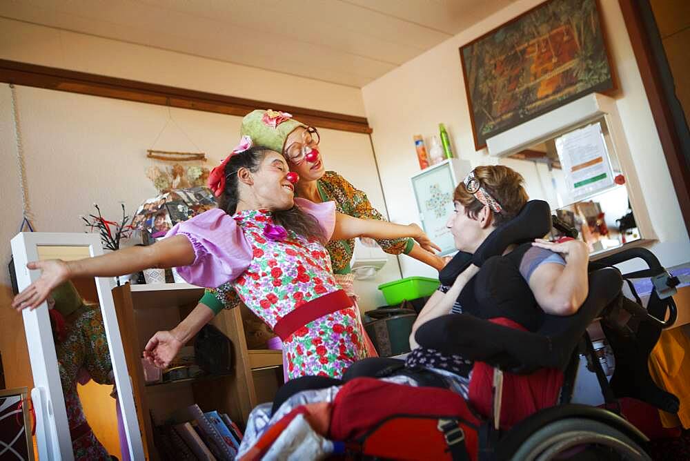 Two clowns from the Hopiclowns association, perform in a home for disabled adults in Geneva, Switzerland.