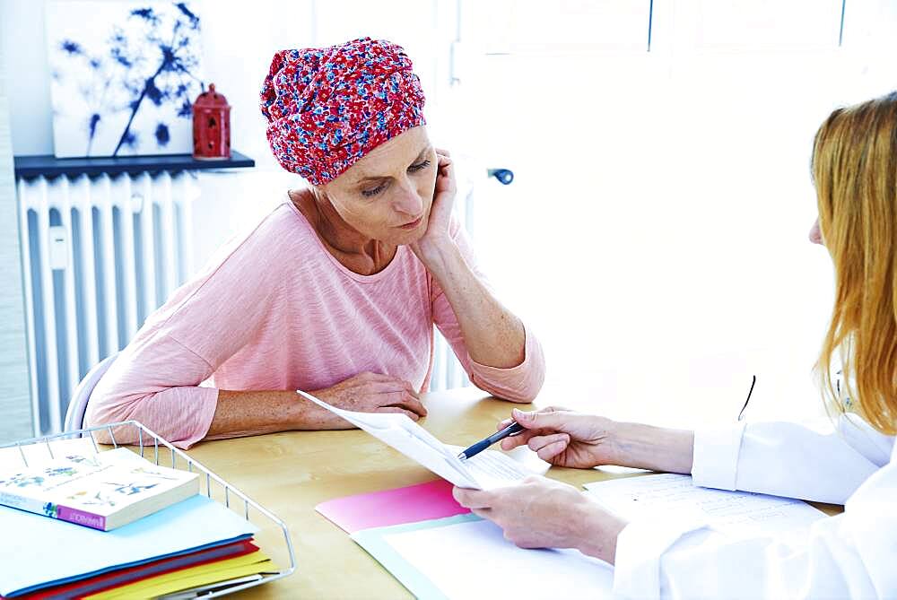 Woman suffering from cancer talking to her doctor.