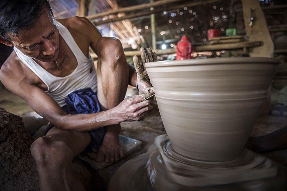 Portrait of a potter in an Oh Bo pottery shed, Twante, near Yangon, Myanmar, Burma