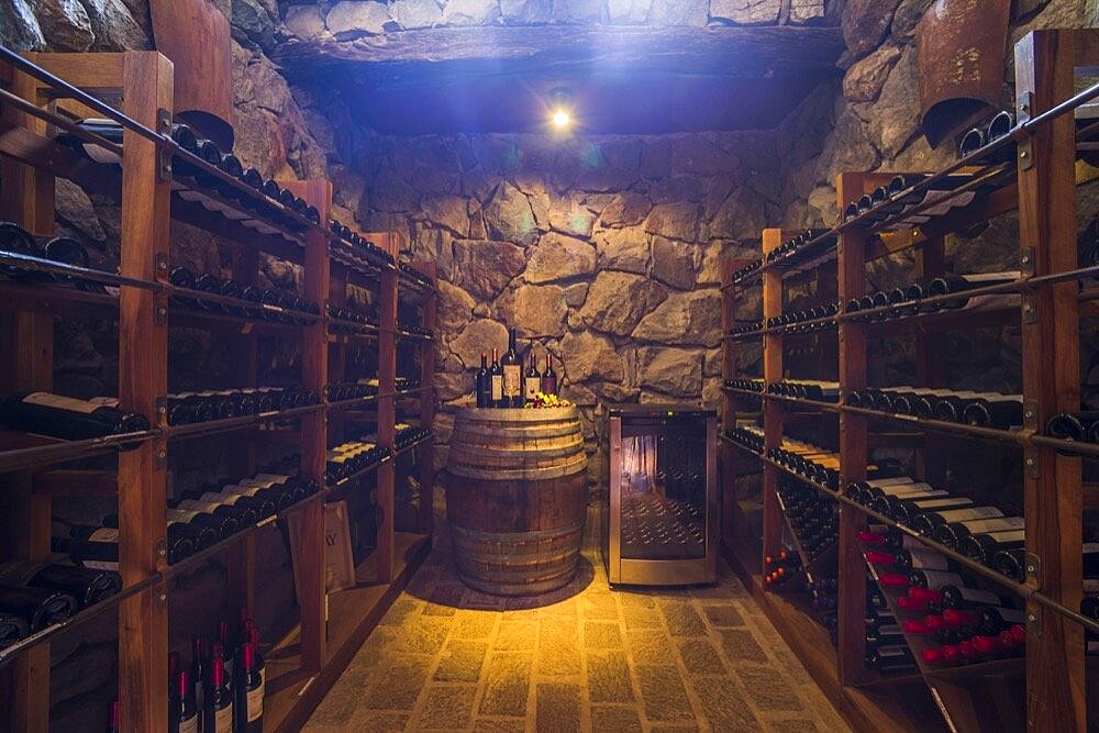 Wine cellar with a wine collection, including expensive bottles of wine and wine barrel, Mendoza Province, Argentina, South America