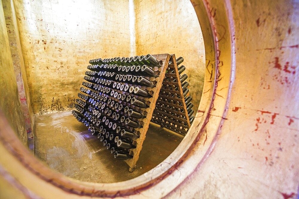 Old vintage wine bottles in a wine cellar at a Bodega, winery, in the Maipu area of Mendoza, Mendoza Province, Argentina, South America