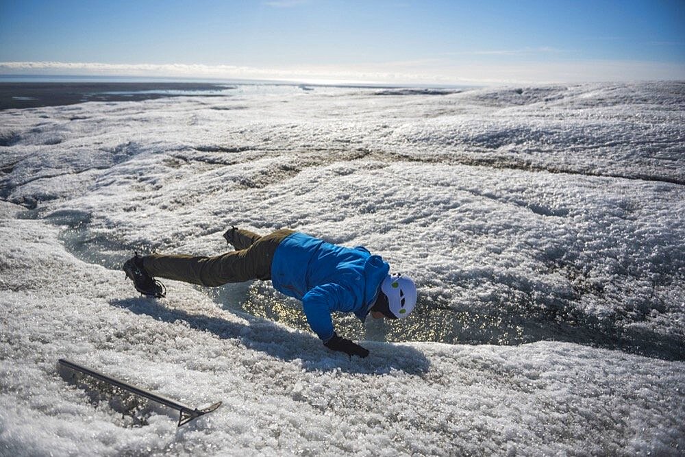 Drinking glacial water on while on a glacier hike on Breidamerkurjokull Glacier, Vatnajokull Ice Cap, Iceland, Europe