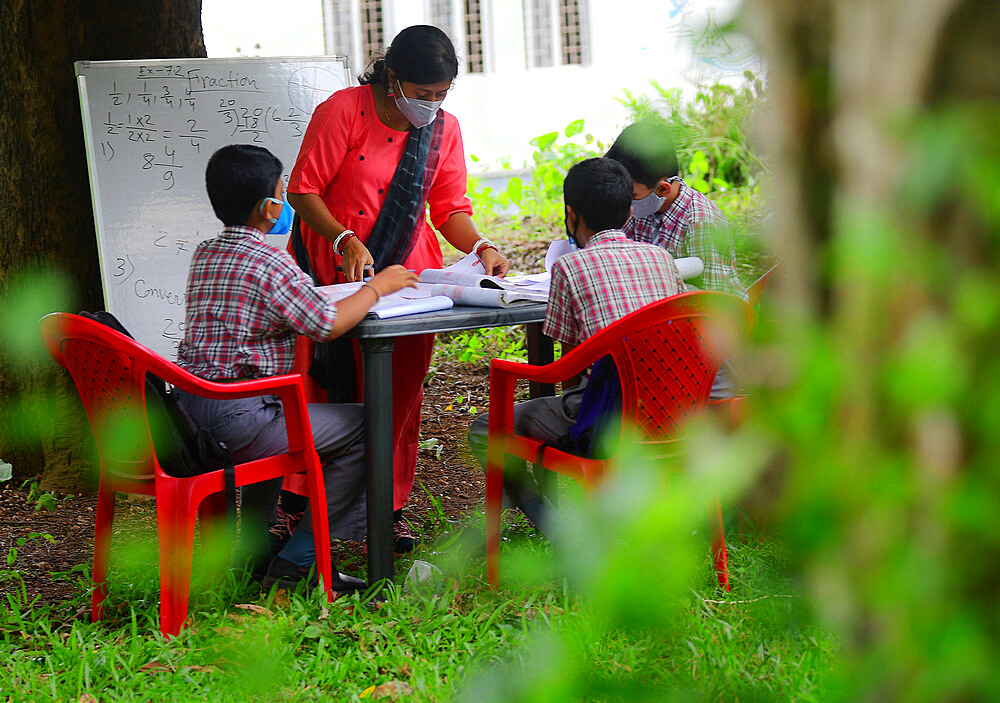 The teachers of Henry Derozio Academy HS School are conducting classes outdoors, maintaining social distancing for the students who could not attend online classes