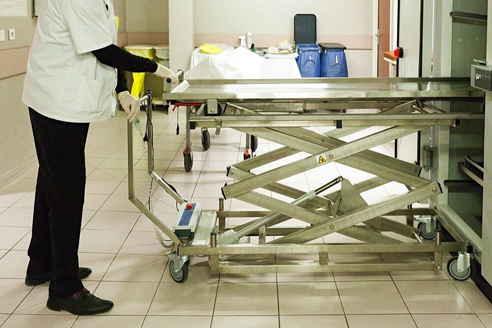 A dead body (corpse) is just arrived in the mortuary chamber in an hospital.