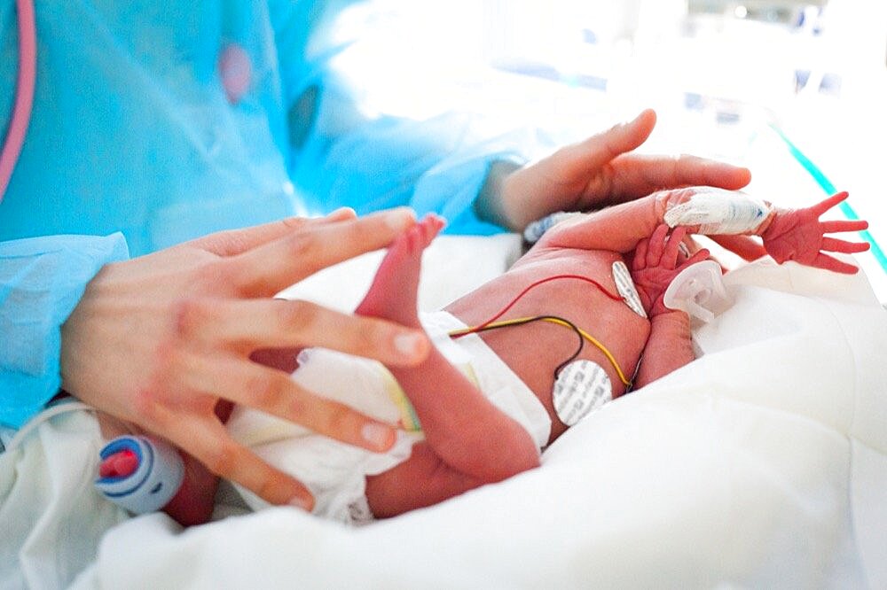 A nursery nurse takes care of a premature baby. Hospital. Aix en Provence.