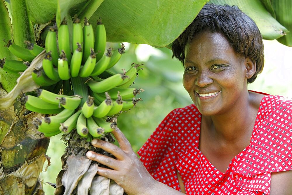 Janet Karimi, in her garden, has been a client of KWFT microfinance since 2007. She is currently servicing a loan of 100,000 KS