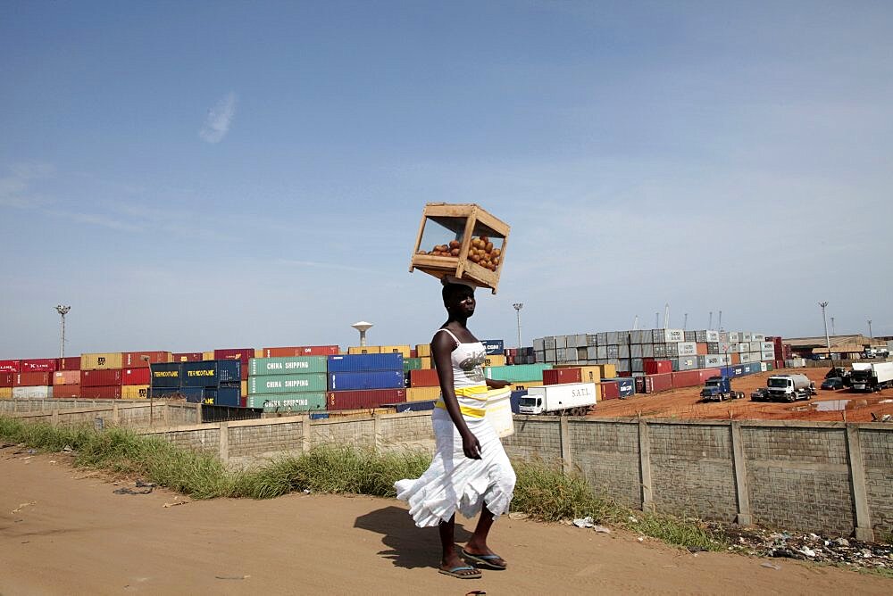 African woman carrying a load on her head.