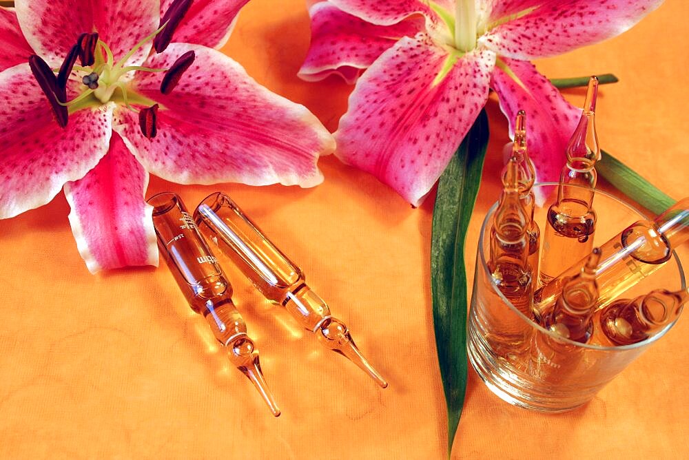 Still life with lilies and liquid in vials