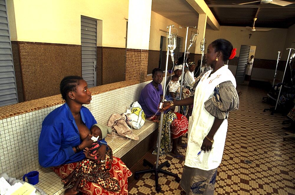 Burkina Faso, Ouagadougou, Mother feeding baby in maternity ward