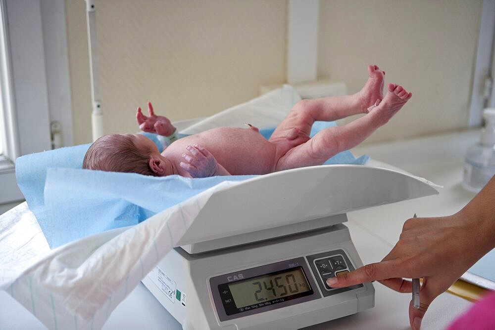 Newborn Baby Being Weighed