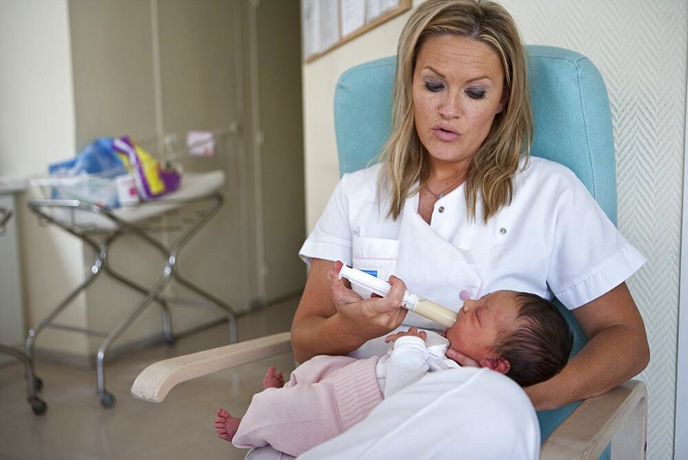 Nurse Feeding Newborn