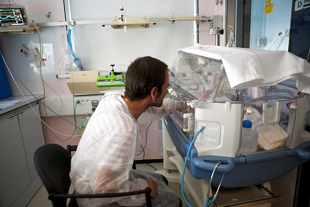 Father comforts Premature Baby