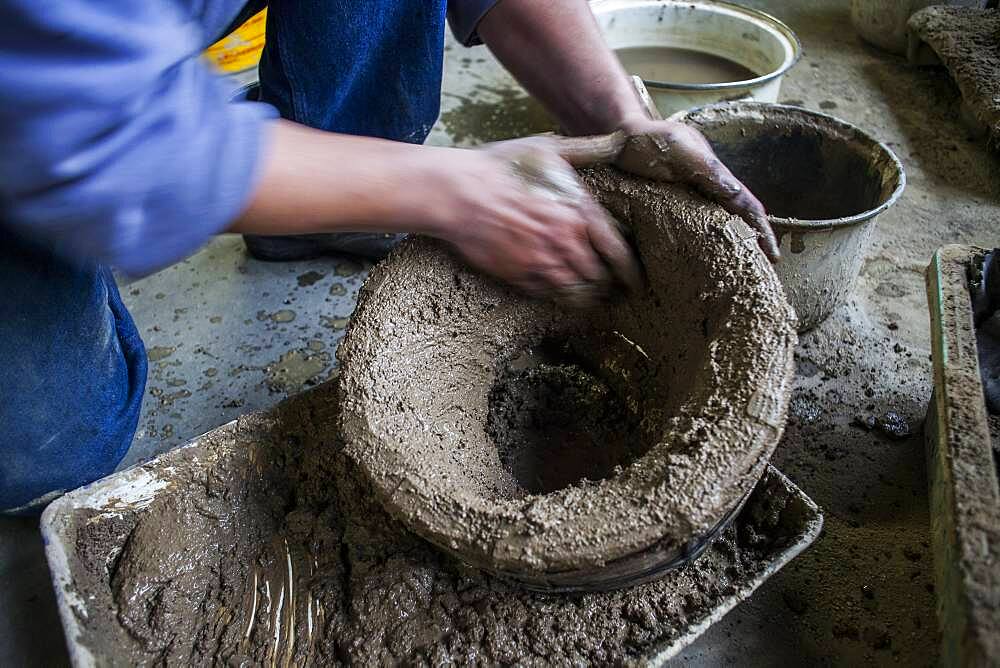 Takahiro Koizumi is making the outer mold of a new design of a iron teapot or tetsubin, nanbu tekki,Workshop of Koizumi family,craftsmen since 1659, Morioka, Iwate Prefecture, Japan