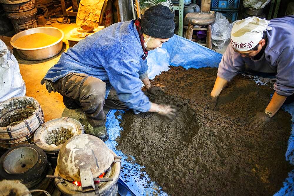 Takahiro Koizumi at right and his assistant kohei ishimori at left  are making mud to build a molds to make a iron teapot or tetsubin, nanbu tekki,Workshop of Koizumi family,craftsmen since 1659, Morioka, Iwate Prefecture, Japan