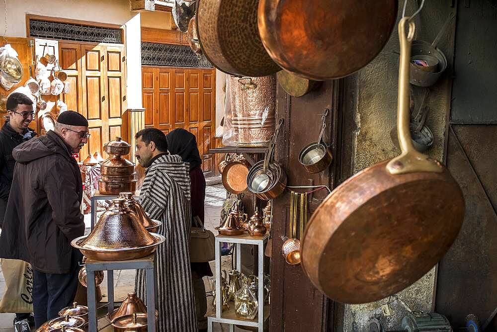 Customers and seller haggling, souk of brass, Place as Seffarine, medina. Fez.Morocco