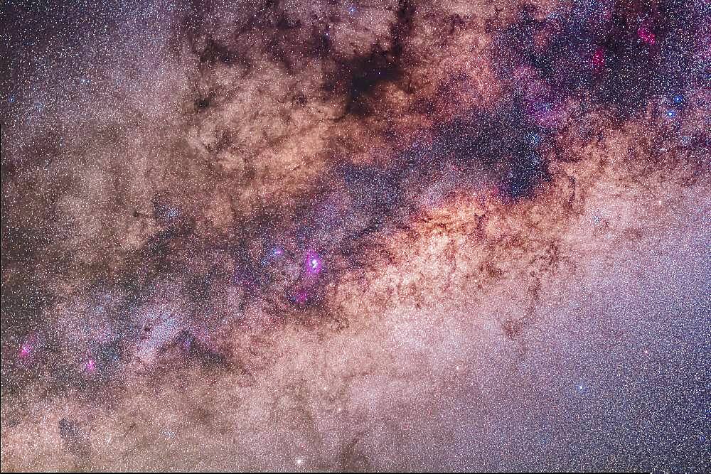 The centre of the galaxy area of the Milky Way toward Sagittarius and Scorpius, with the Sagittarius Starcloud right of centre, and the Lagoon Nebula (M8) left of centre. The Cat's Paw Nebula (NGC 6334) in Scorpius is at upper right, the Swan Nebula (M17) and Eagle Nebula (M16) are at lower left. To the right of them is the Small Sagittarius Starcloud (M24). At the very top is the Snake Nebula (B72). The main mass of dark nebula is the Pipe Nebula (B78). Above M24 at left is the open cluster M23 while below the M24 star cloud is the cluster M25. The globular M22 is at the bottom edge. At right of frame are the open clusters M6 (in the dark area of the Milky Way) and M7 (in the bright starcloud).