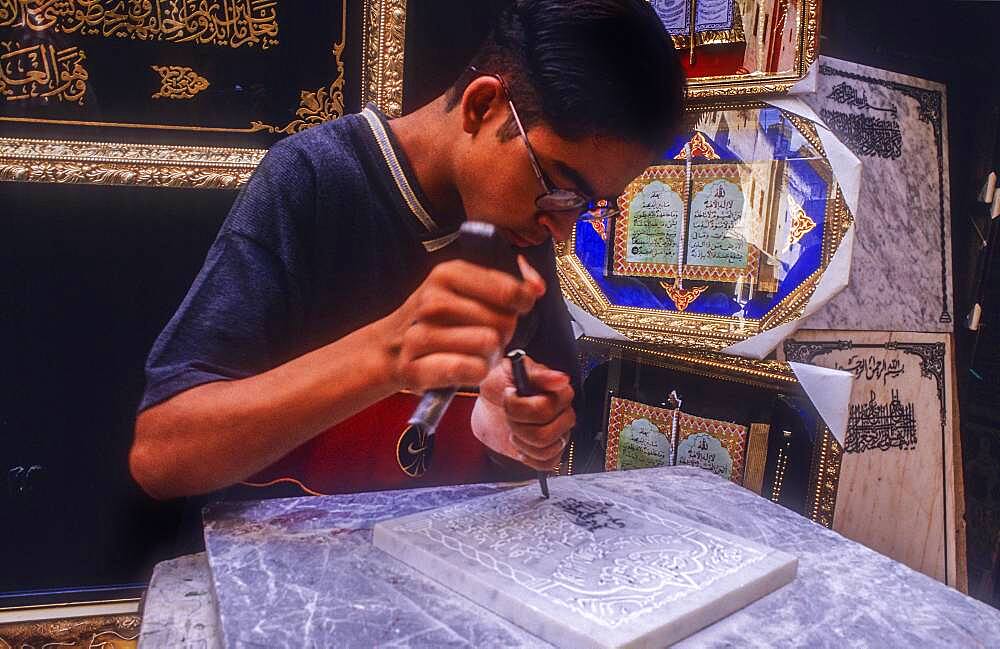 Craftsman making a gravestone, Medina, UNESCO World Heritage Site, Fez, Morocco, Africa.