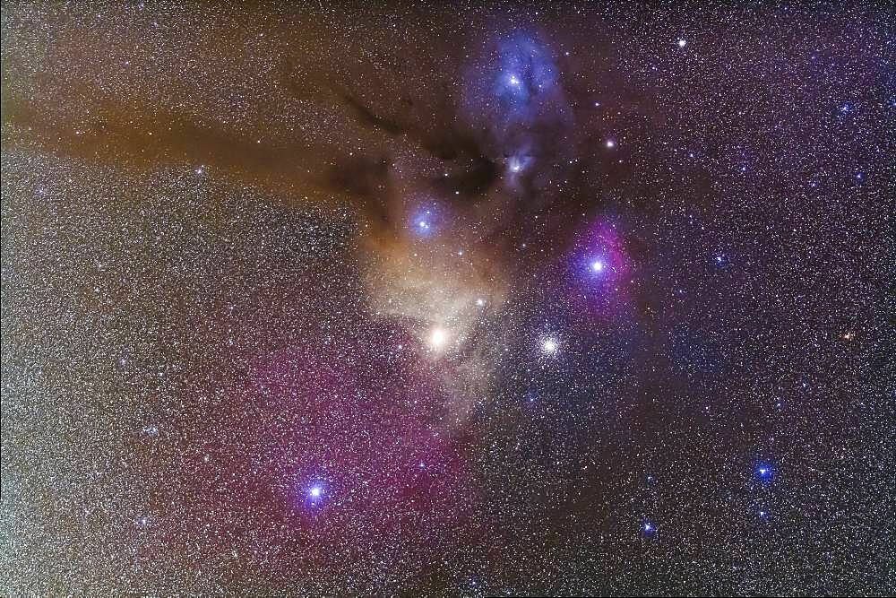 The colourful region around Antares in Scorpius, the yellow star at centre. To the right is the globular cluster Messier 4. Above right of Antares is the smaller globular NGC 6144. Above are the nebulas associated with Rho Ophiuchi. The area is filled with reflection (yellow and blue) and emission nebulas (red and pink). The field simulates a binocular field.